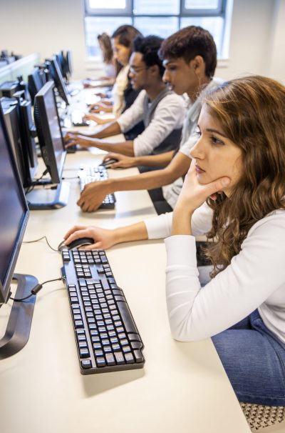 Senior school students working on their computers in class. From a series of high school education related images.